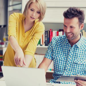 Bookshop managers working on laptop
